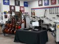 cello and double bass carts next to a black table in a music store