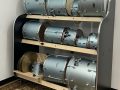 black rack holding silver drums