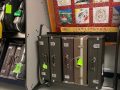 saxophone cases in rack under a bulletin board