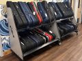 two shelves filled with violin cases, placed in the hallway of a school