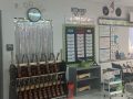 a cart full of ukuleles next to a decorated wall in a music classroom
