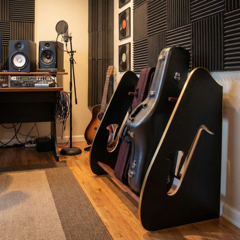 wooden saxophone case rack placed against the wall of a recording studio